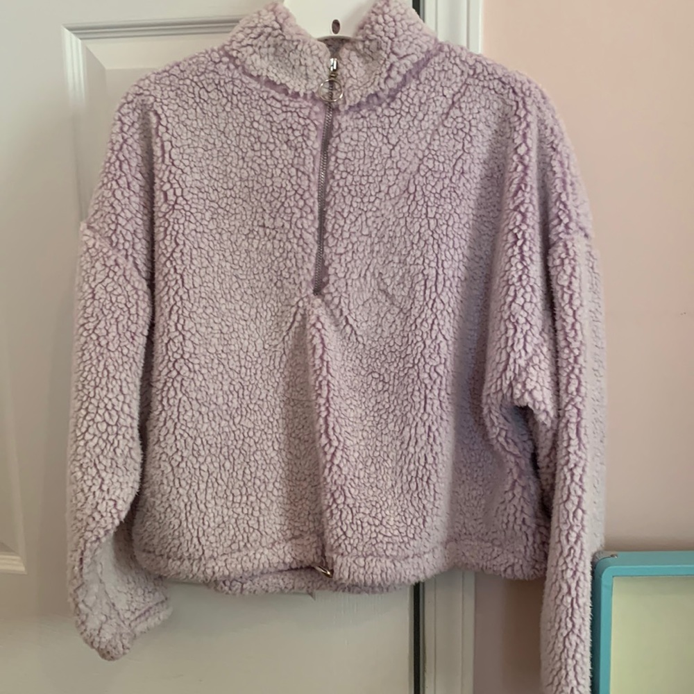 youth L fleece quarter zip pull over in light purple.